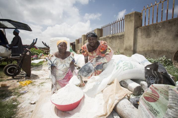 Women sell cassava flour at a market in Abuja, Nigeria.