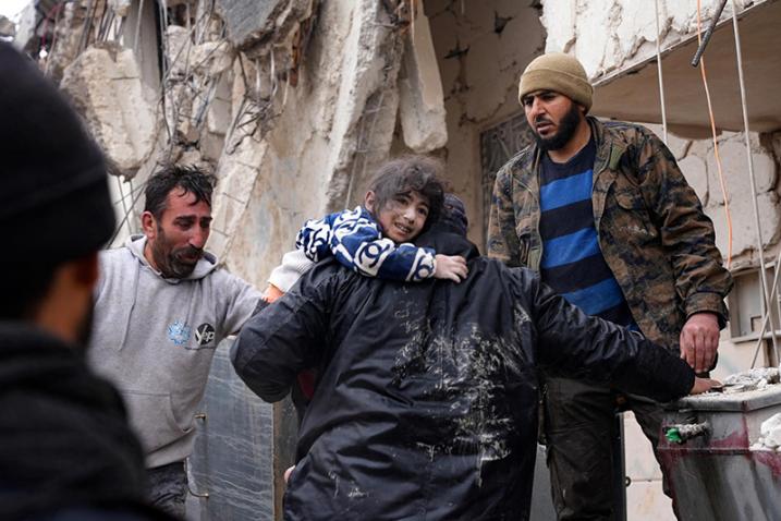 child being rescued from earthquake rubble