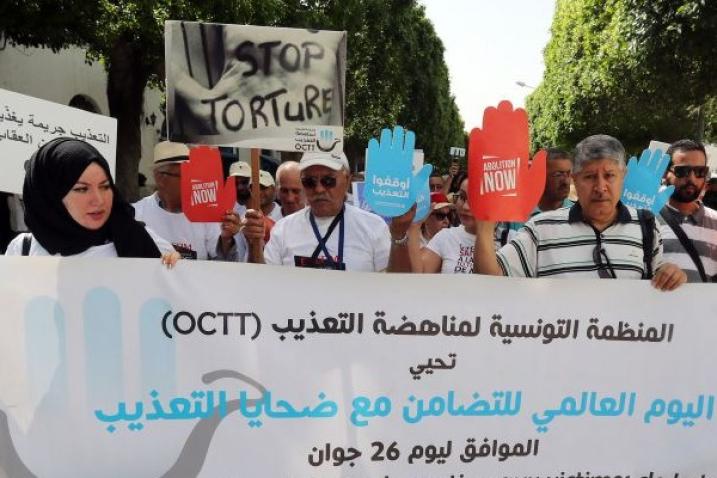 People with placards demonstrating against torture