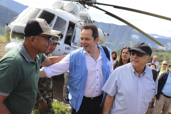 Head of the United Nations Verification Mission in Colombia greets an ex-combatant while visiting a reintegration area for former combatants. 