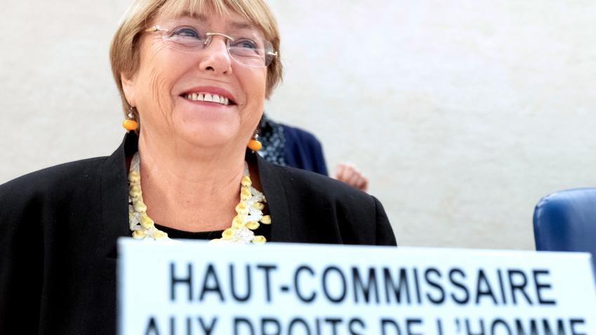 Michelle Bachelet sitting at the head-table of a conference room