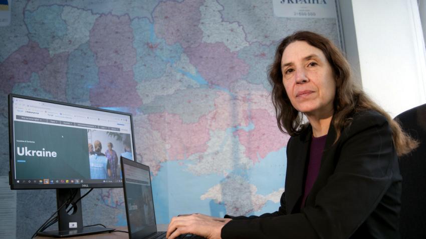 Matilda is pictured at her desk with the world map in the background