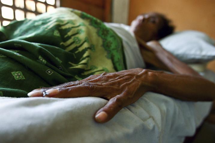 HIV/AIDS patient lies in bed in health clinic in Timor-Leste in 2008.