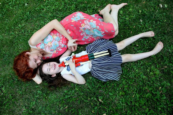 Mariam, 7, lies in the grass with her mother at Boghossian Gardens, Yerevan, Armenia.