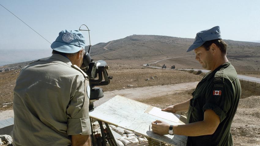  Two male observers observe machine-gun fire by Israel forces,