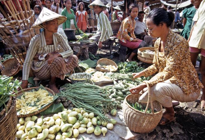 Women buying vegetables at fruit stall