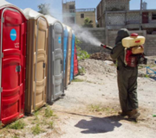 A UN peacekeeper fumigating mosquitoes in the Bel Air neighbourhood of Haiti’s capital Port au Prince. Photo: UN/MINUSTAH/Logan Abassi