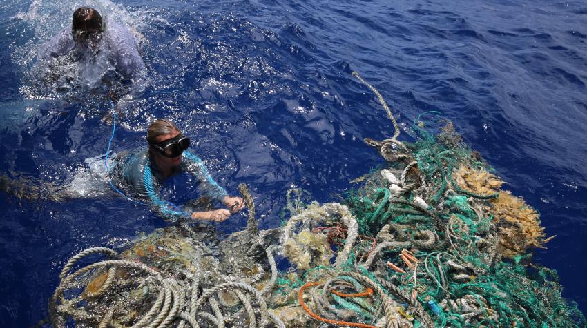 Emily Penn attaches a tracking device to a floating mass of ocean debris in the North Pacific Gyre, 2018. eXXpedition/Lark Rise Pictures