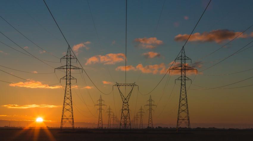 Transmission towers line along a rural area