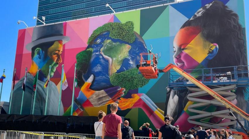 UN News/Matthew Wells. Artist Eduardo Kobra and his team putting the finishing touches to his mural outside UN Headquarters.