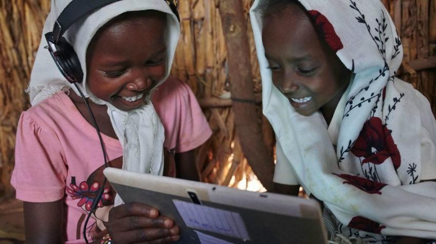 © UNICEF/Shehzad Noorani. Children use their tablet in a village in Eastern Sudan.