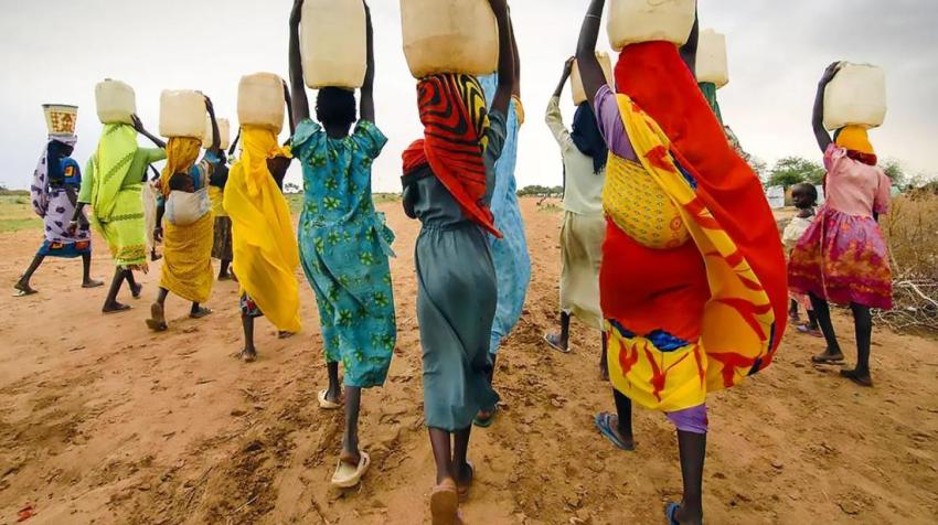 Image by RM Photography. Women carrying water on their heads, near the city of Tanzania, Dar Es Salaam. 