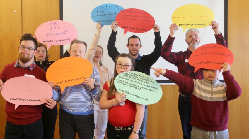 A group of self-advocates choosing messages to share at a 2018 conference event. Down Syndrome International