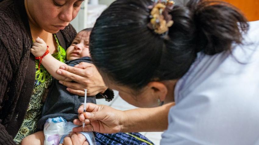 © UNICEF/Patricia Willocq. A five-month-old child receives a vaccine at a health centre in Alta Verapaz, Guatemala.