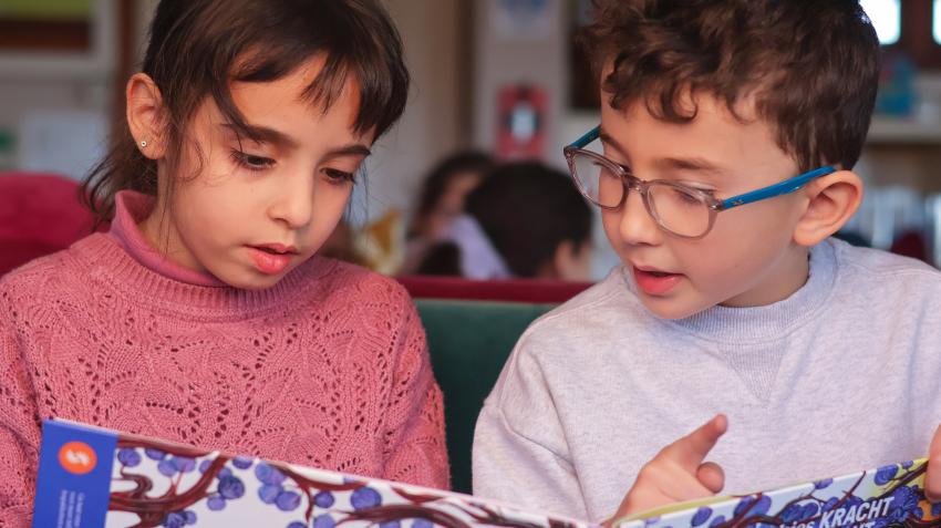 Two children learning with one of the mindset education books of Sustainable Stories on the United Nations Sustainable Development Goals (SDGs). ©Sustainable Stories Two children learning with one of the mindset education books of Sustainable Stories on the United Nations Sustainable Development Goals (SDGs). ©Sustainable Stories