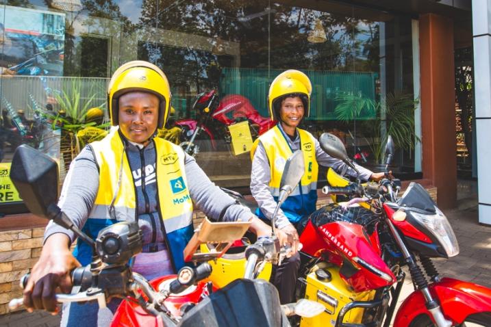 Two young people ride e-motorcycles