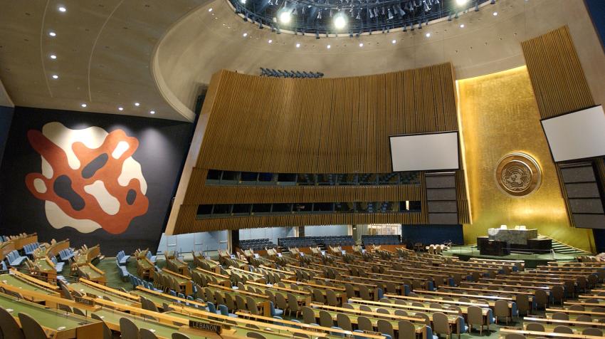 Overview of the General Assembly Hall and the red, white, and dark navy mural from the right side of the chamber.