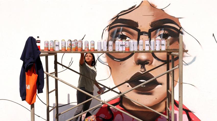 A group of graffiti artists (all young women) painted orange murals in Zone 18 in Guatemala City in support of UN-Women and the UNiTE campaign to End Violence against Women. Guatemala City, Guatemala. 2 December 2018.   