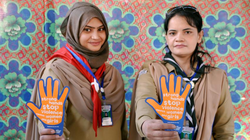 Pakistan-Balochistan girl scouts hold orange hand sign that says "strong hands stop violence against women and girls"
