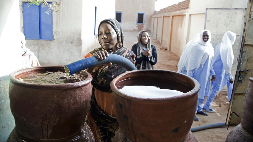 Women filling jugs with fresh water