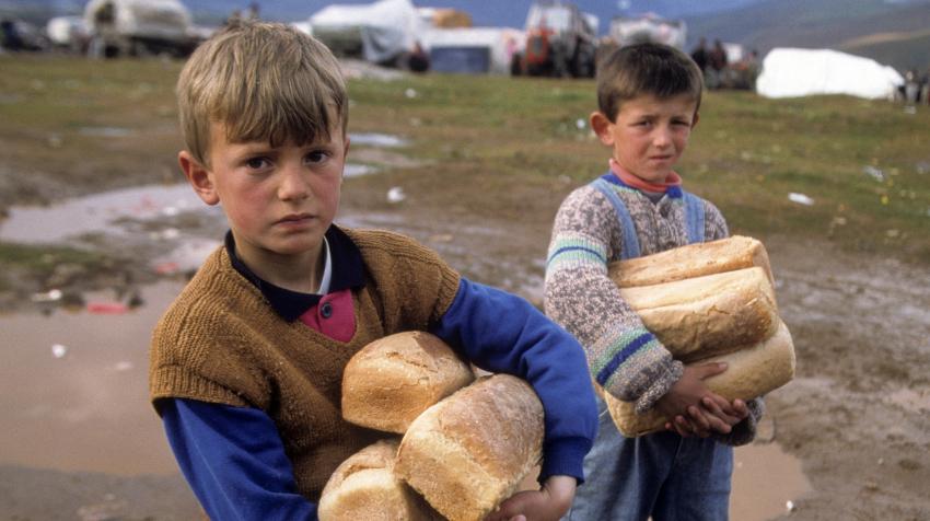 Two boys are carrying their families' bread rations