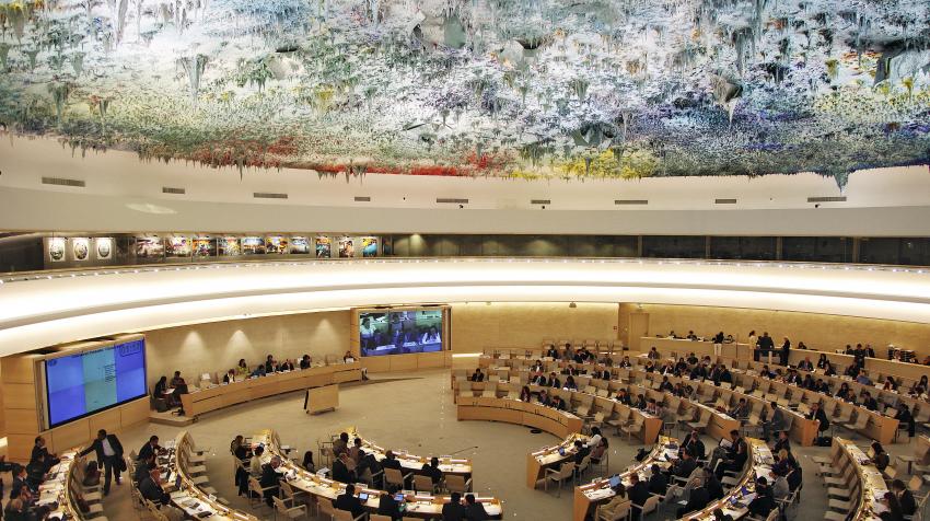 General view of the circular conference room with a sculpture ceiling above several rows of curved tables. UN Photo/Jess Hoffman