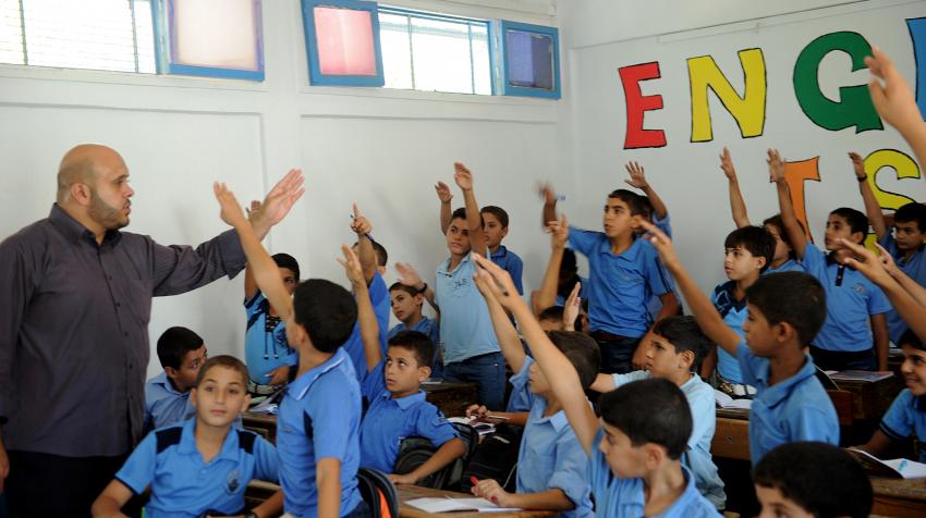 Boys raise their hands during a class at a school in Gazar supported by the United Nations Relief and Works Agency for Palestine Refugees in the Near East. 