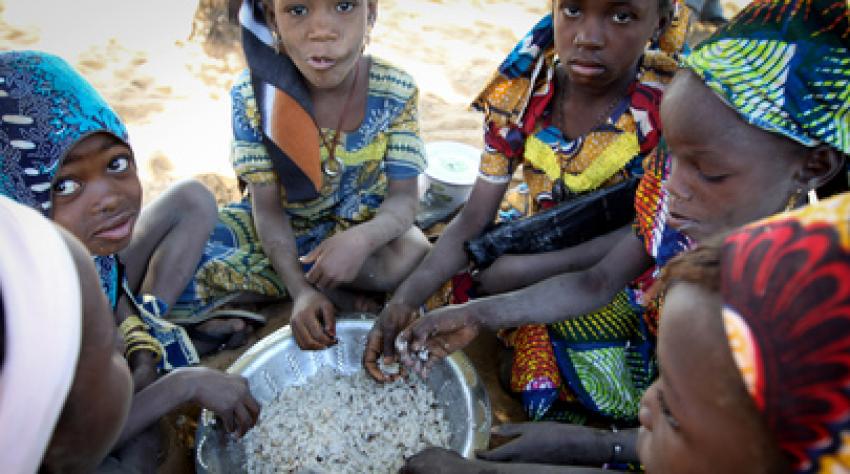Young girls eat a midday meal at the World Food Programme (WFP) school feeding centre in Guidam Makadam, Niger.