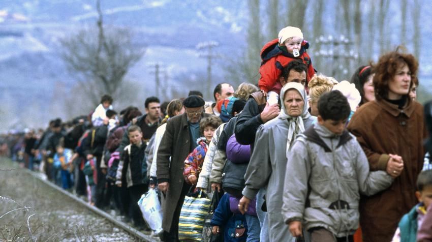 A massive line of Kosovar refugees who are fleeing from their homeland.