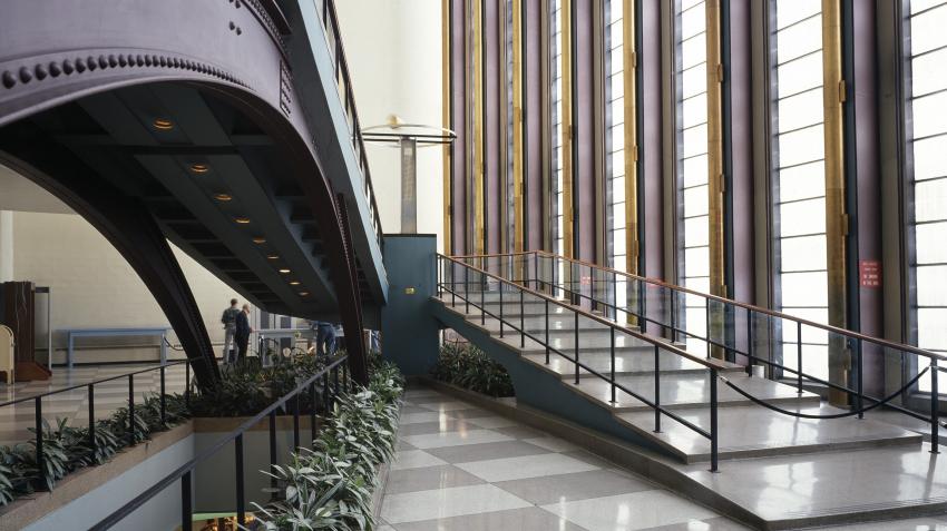 View of public lobby in the General Assembly building with staircases leading to the second floor on right and those leading to the basement on the left of the picture.