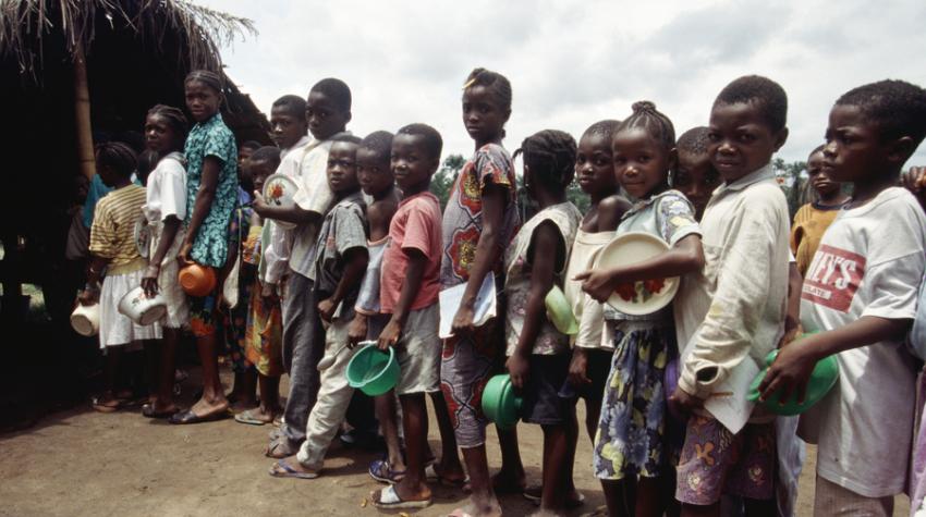 Children line up for food in a refugee camp in Liberia, run by the office of the United Nations High Commissioner for Refugees.