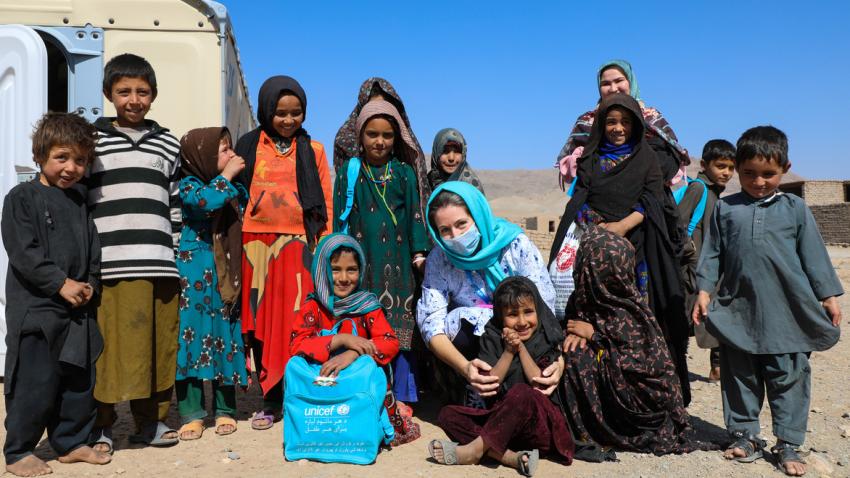 Sam Mort poses for a photo with children