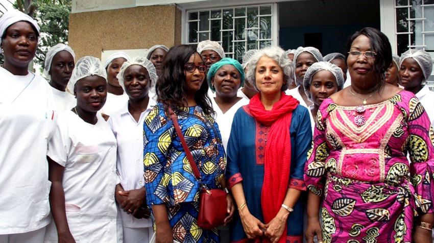 Dr. Soumya stands for a photo op surrounded by health workers