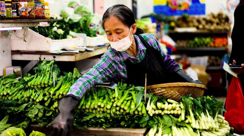 Woman in vegetable stall hong kong market