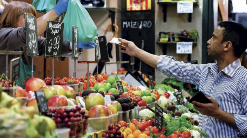 Photo of man buying food at an outdoor market