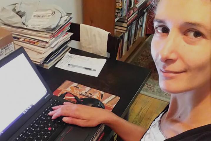 Close-up of a woman and her laptop.