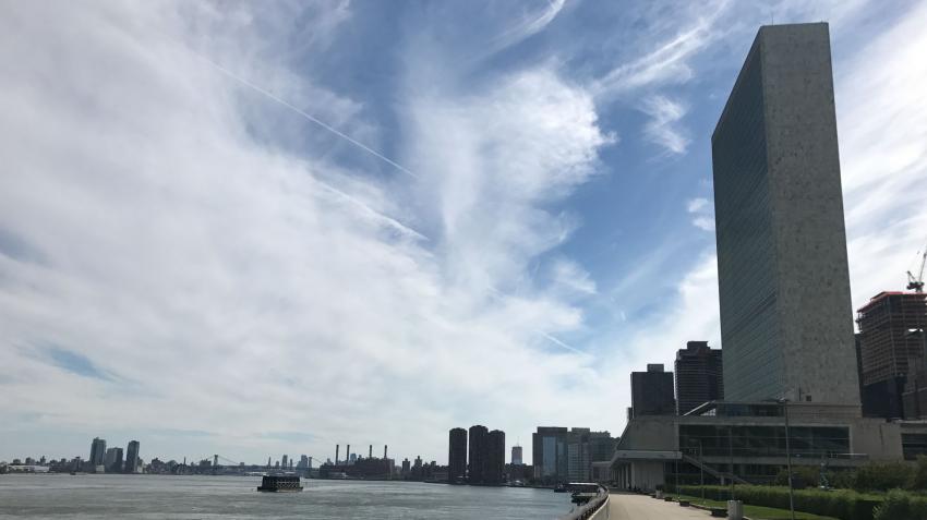 View of east river and the UN headquarters building from the Secretariat Building patio in the green area. 