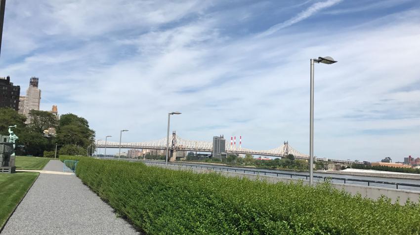 Green area near the East River, with statues from member states and pebbled trail. 