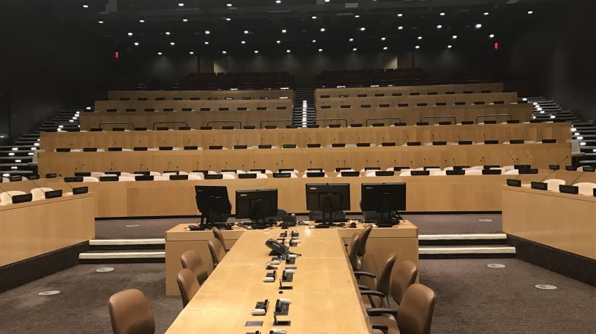 View of the ECOSOC chamber from the front of the room, with several floors of chairs for both speakers and the audience. 