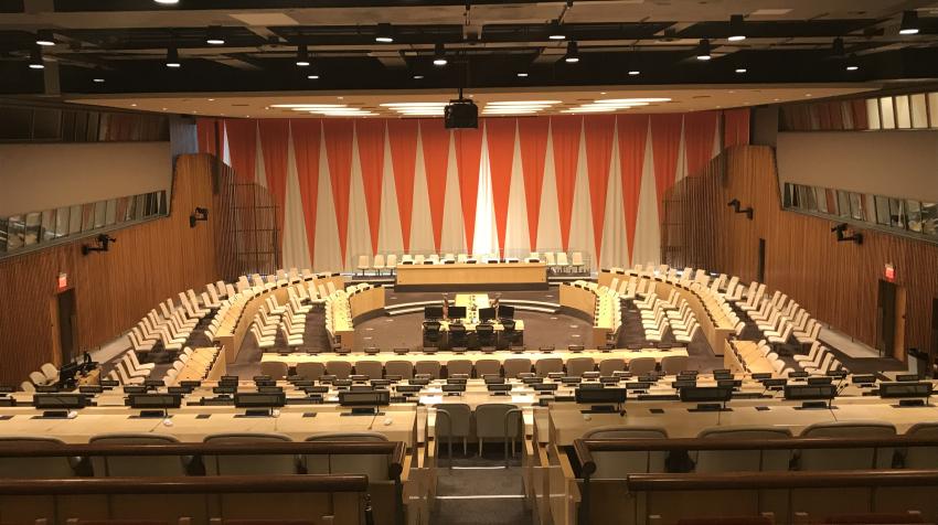 Overview of the ECOSOC chamber, with reclining seats for audience and actual chamber with seats arranged around the room. 