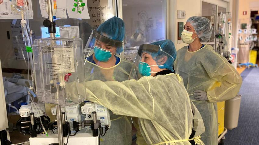 A group of healthcare professionals treat #COVID19 patients female medical professionals setting up equipment at hospital