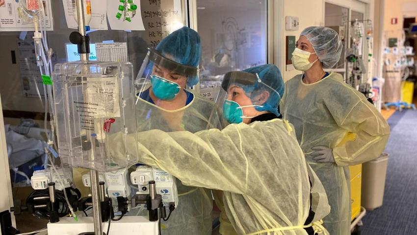 female medical professionals setting up equipment at hospital