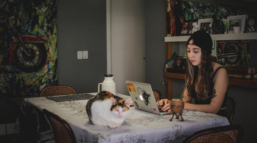 Joana Berwanger sits with a 'chimarrão', a typical south-Brazilian drink, and her cat in Porto Alegre, Brazil. United Nations photo: Joana Berwanger