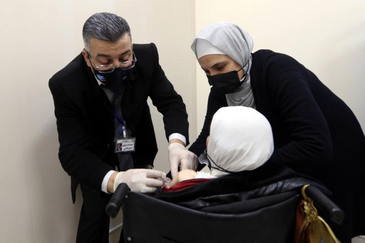  A woman with disability receives COVID-19 vaccine in Amman, Jordan