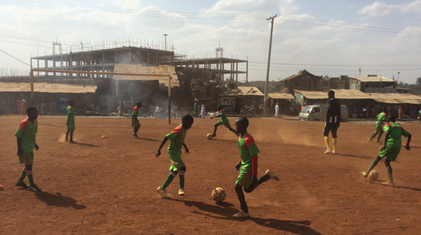 Children play football at the ACAKORO Football Academy in the Korogocho section of Nairobi, Kenya, September 2015. © UNOSDP