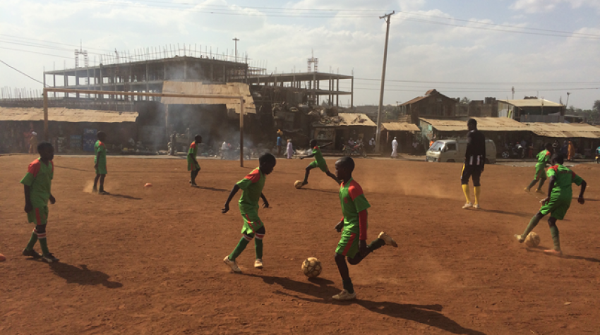 Children play football at the ACAKORO Football Academy in the Korogocho section of Nairobi, Kenya, September 2015. © UNOSDP