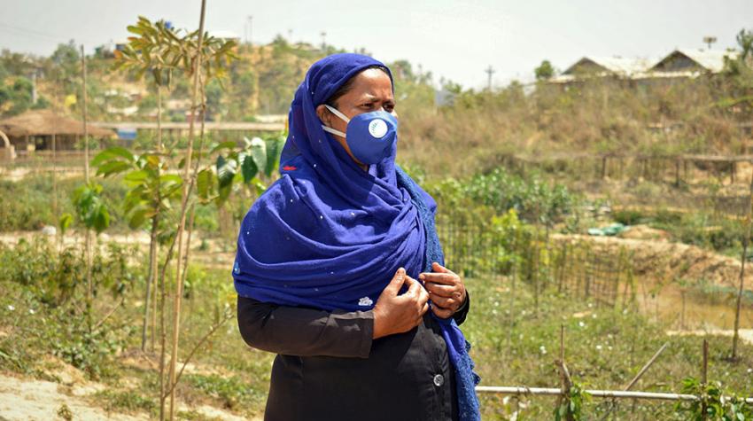 woman with face mask standing in garden