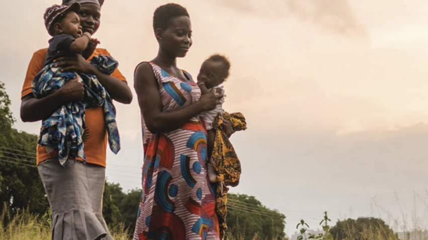 Parents walking and carrying their children