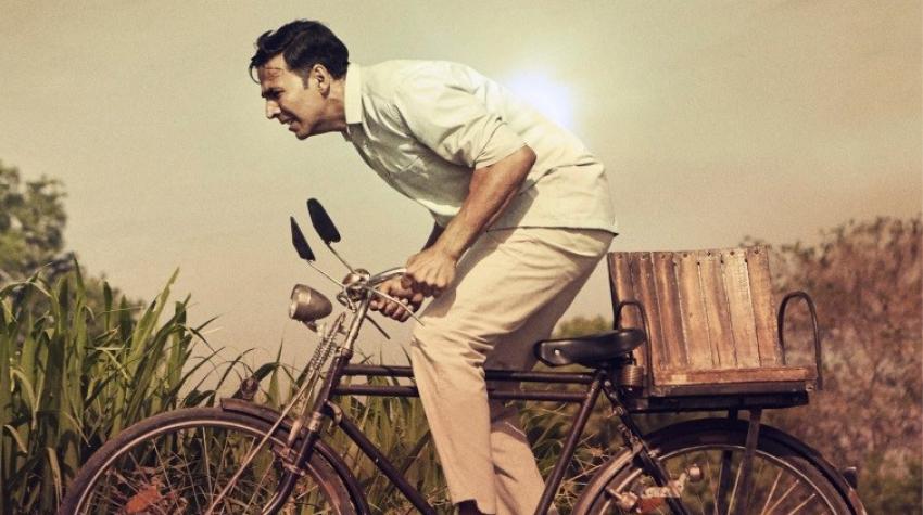 Movie poster of a man riding on a bike. 