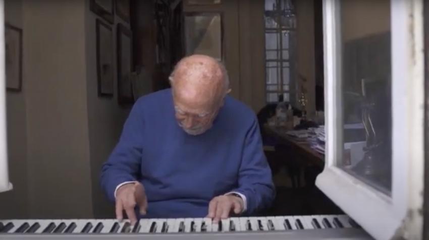 Simon Gronowski serenades his neighborhood from his windows in Brussels, Belgium.